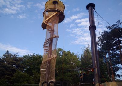 A zipline is built on a tower with a spiral staircase