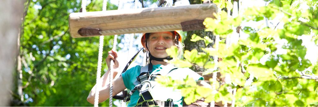 A child climbs in the high ropes course