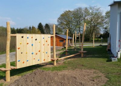 Construction of a playground with climbing wall made of robinia