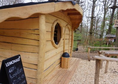 Rustic hut made of robinia as a cash desk in a climbing forest