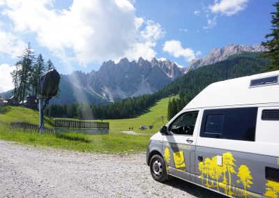 Cambium assembly vehicle in front of a mountain panorama