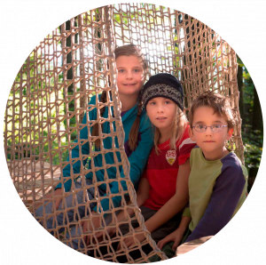 Children sitting in the net of a climbing element